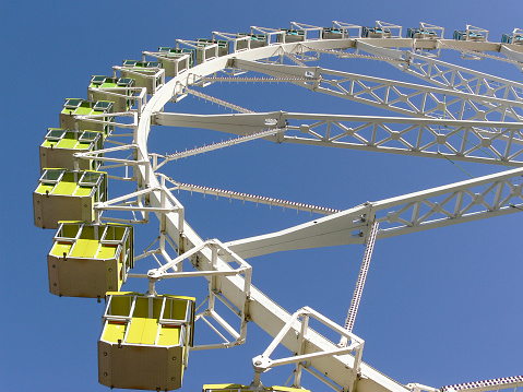 A rollercoaster doing a loop against a blue sky.
