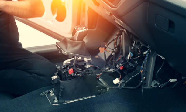 Dismantling car interior. Disassembled multimedia panel and gear lever for repair, replacement, maintenance or dry cleaning detailing stock photo