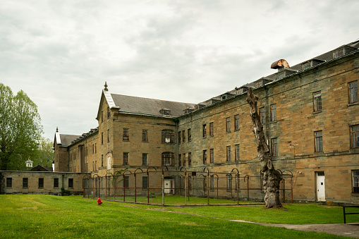 West Virginia, USA - May 17, 2022: Exterior of the Trans-Allegheny Lunatic Asylum, a historical building dating from 1864. Also known as Weston State Hospital, this famous Kirkbride psychiatric hospital operated until 1994. Now a popular tourist attraction, tours offered include historical, architectural and paranormal.