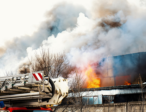 Fire with smoke in industrial factory or warehouse with big flame.
