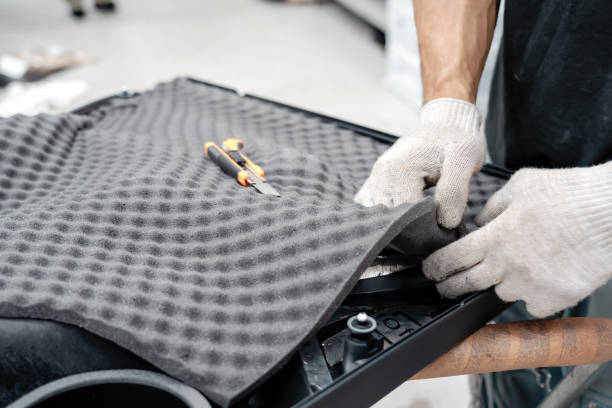 istock Auto service worker installing soundproofing foam material on car door trim from inside, tuning car sound or installing noise insulation 1425033673