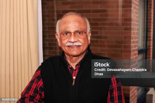 A 75 Year Old Asian Indian Man Looks Directly Into The Camera And Smiles Stock Photo - Download Image Now