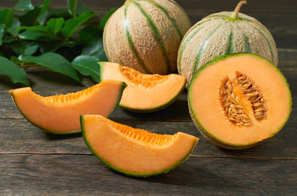 istock sliced cantaloupe melon on a wooden table, selective focus. 1425039244