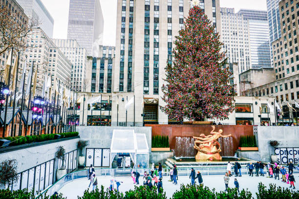 Rockefeller Tree Rockefeller Tree and people ice skating underneath, in midtown New York City. Photographed on December 18, 2021 rockefeller ice rink stock pictures, royalty-free photos & images