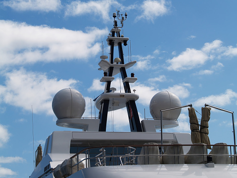 Radar Tower And Decks Secured In Harbor Against Blue Sky With Clouds