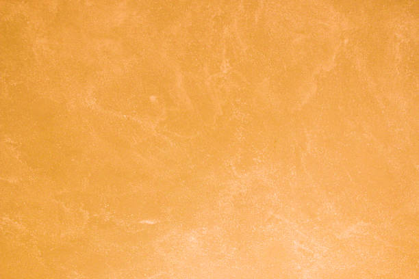 istock Texture of old orange plaster damaged by weather. 1425044536
