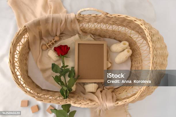 Letter Board Baby Announcement With Basket Baby Clothing Mock Up Space For Design Pregnancy Announcement Background With Blurred Selective Focus Stock Photo - Download Image Now