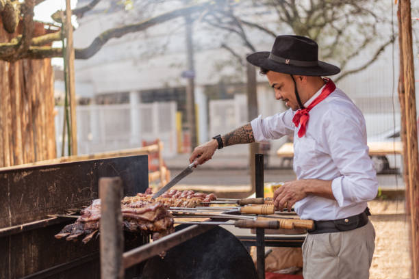 Gaucho making barbecue at the farroupilha camp