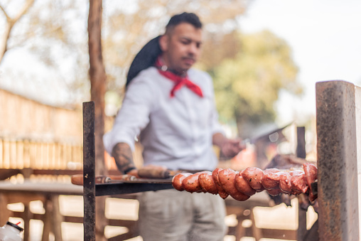 Gaucho making barbecue at the farroupilha camp
