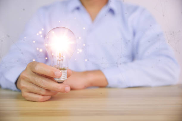 istock businessman holding a light bulb graphic Digital technology abstract. imagine an idea Creative and innovative. brain to brainstorm ideas in business. Strategies for development, growth, and success 1425051073