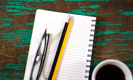 Ready to Work: Notebook, Coffee, Two Pencils, Glasses, Turquoise Background