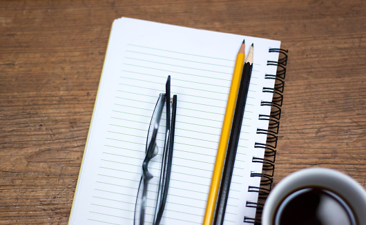 Ready to Work: Notebook, Coffee, Two Pencils, Glasses, Turquoise Background