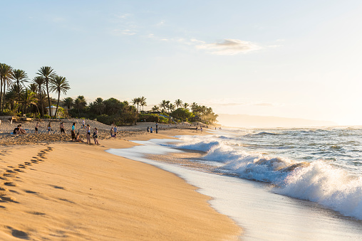 Sunset Beach, Oahu Hawaii, USA   circa February 2018: People at Sunset beach at sunset.  Sunset Beach is located on the north shore of Oahu and is the best place to watch the sunset in the island