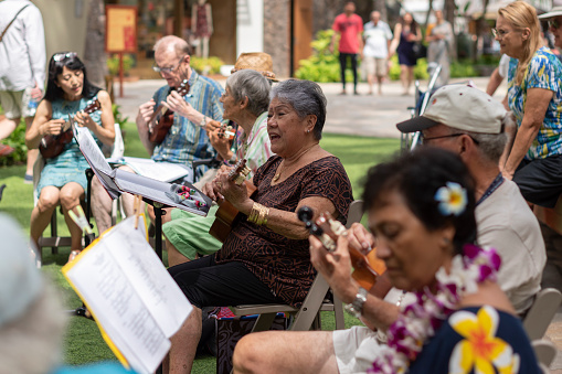 Waikiki, Oahu, Hawaii, USA  February 2018: Local people singing and playing ukelele in a Waikiki event