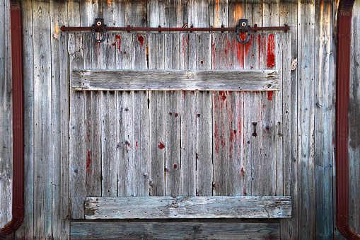 a rustic old farm barn sliding door entrance farming storage wooden boards weathered vintage retro building exterior doorway