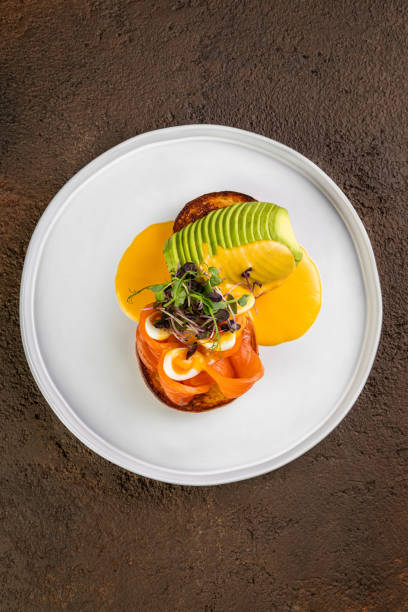 istock Delicious healthy breakfast, snack - sandwich with avocado, plates  on white table background. 1425071461