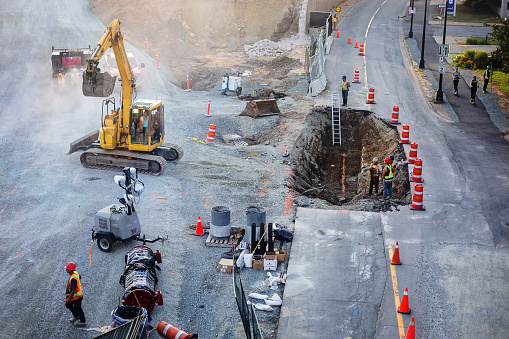 Halifax, Canada - August 29, 2022. Construction workers and machinery with road repairs underway on Upper Water Street in downtown Halifax.