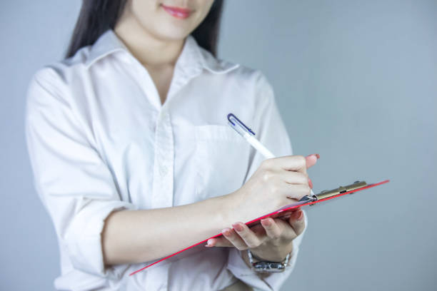 istock Portrait of a beautiful businessman standing on a checklist, taking notes on background. 1425073607