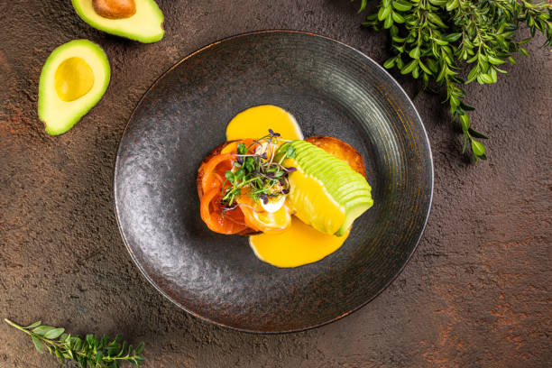 istock Close-up of egg Benedict with ham, Eggs Florentine close up on a black plate 1425074706