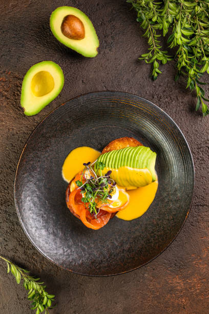 istock Close-up of egg Benedict with ham, Eggs Florentine close up on a black plate 1425076039