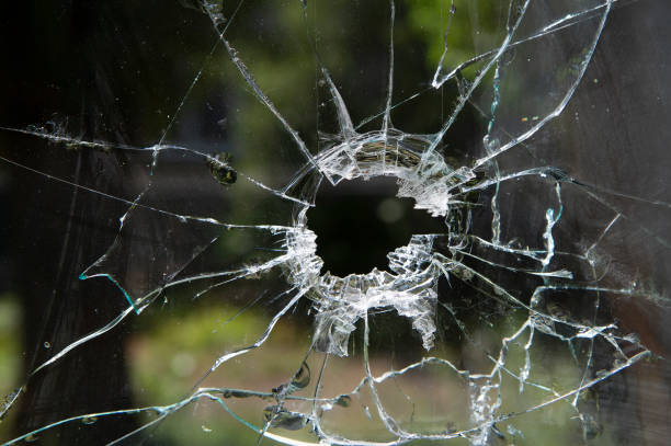 istock Window glass broken by a bullet. Aftermath of hostilities. 1425084747