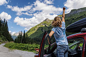 Woman enjoying road trip in high Austrian Alps