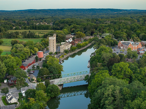 Pittsford, NY is located in Updated New York, southeast of Rochester, NY.  Early evening aerial photo of Schoen Place and the Erie Canal in the Village of Pittsford, New York.
