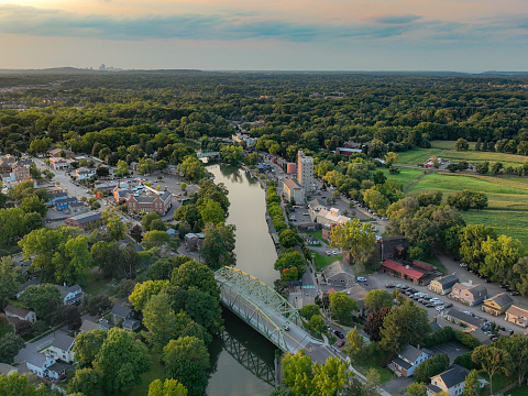 Pittsford, NY is located in Updated New York, southeast of Rochester, NY.  Early evening aerial photo of Schoen Place and the Erie Canal in the Village of Pittsford, New York.
