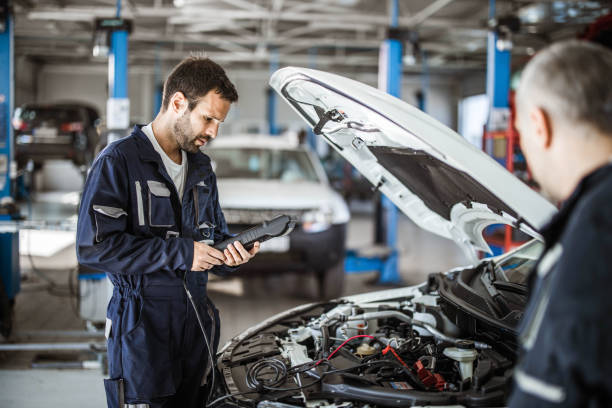 istock Auto mechanic working with car diagnostic tool in a repair shop. 1425092029
