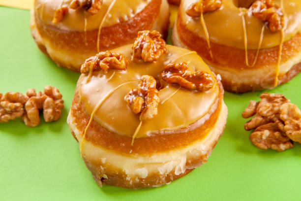 istock Walnut flavoured caramelised gourmet brioche doughnuts closeup. 1425092378