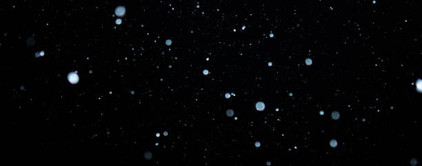 istock Blurred snowflakes on a dark background. Overlay image for snowfall effect 1425093797
