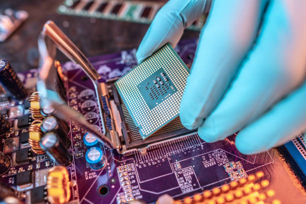 istock Engineer repairman holding hands CPU to insert into the socket of the motherboard. Technology hardware in the neon light 1425098805
