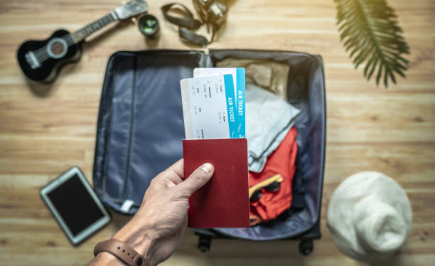 istock Packing a suitcase for a summer vacation. Preparation of things and documents for a trip to the sea by plane 1425102239