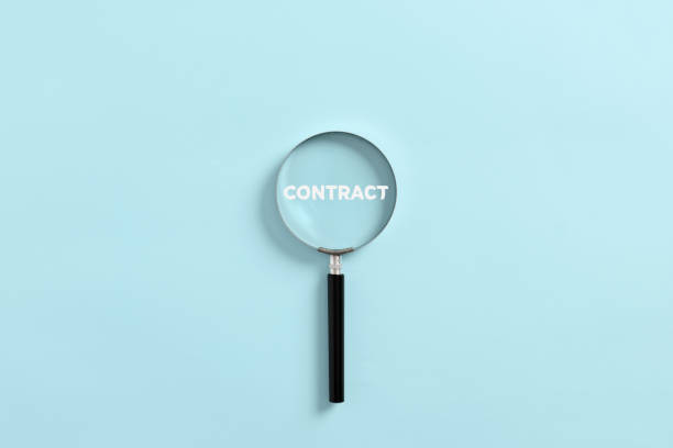 istock Magnifying glass magnifies the word contract. Analyzing or investigating the business contract 1425102970