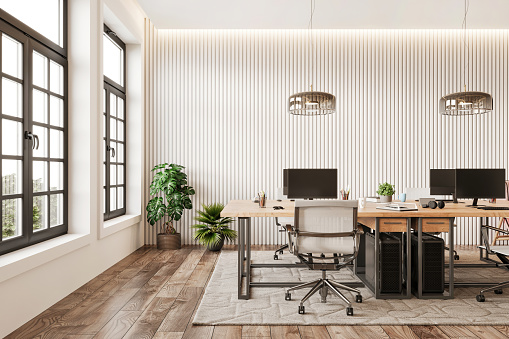 Modern office space interior. Large desk, computers, chairs, parquet, carpet, pendant lamp, white wall, LED light, decoration. Template for copy space. Render.