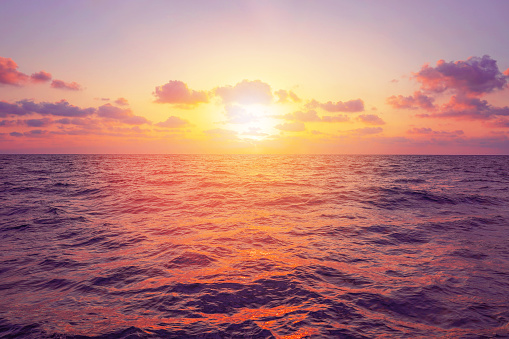 Sunset over sea. Fantastic sunset over ocean with sea waves. Sunset over sea landscape. Beautiful sunset over the ocean