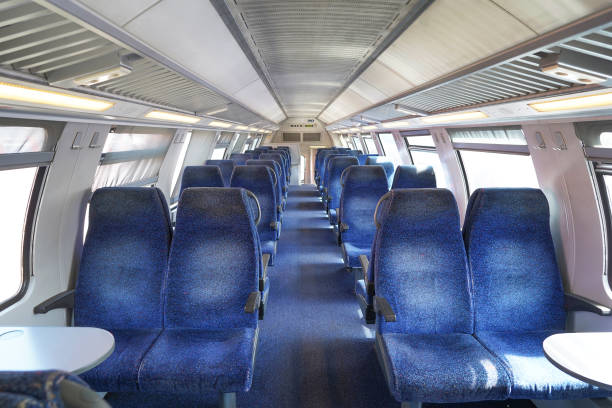 istock Empty cabin of a modern passenger train. Interior design of a modern train. Empty train interior. Public transport in the country. Passenger transportation. Train with blue seats 1425105769