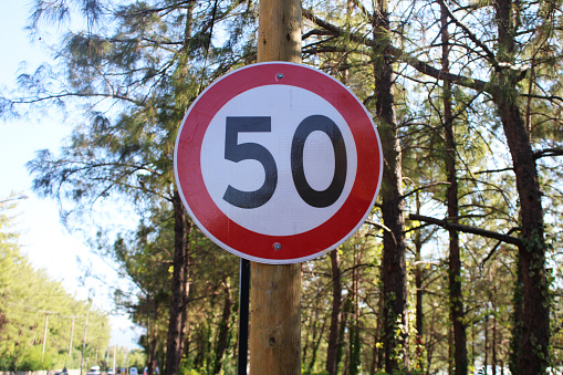 Roadside 50 kilometers speed limit traffic sign. Vertical composition.
