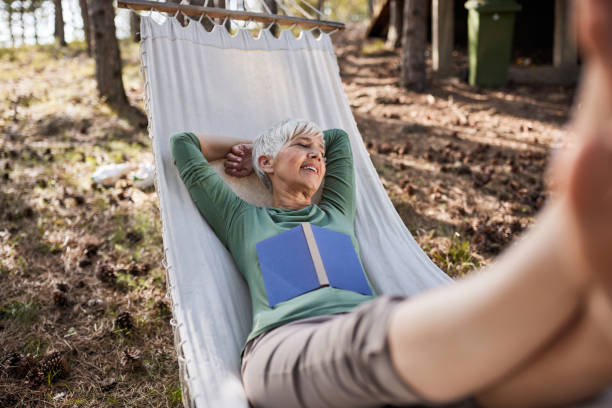 istock Happy senior woman enjoying in hammock. 1425111659