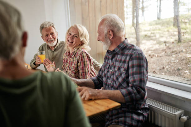 istock Happy mature friends talking in dining room. 1425111763