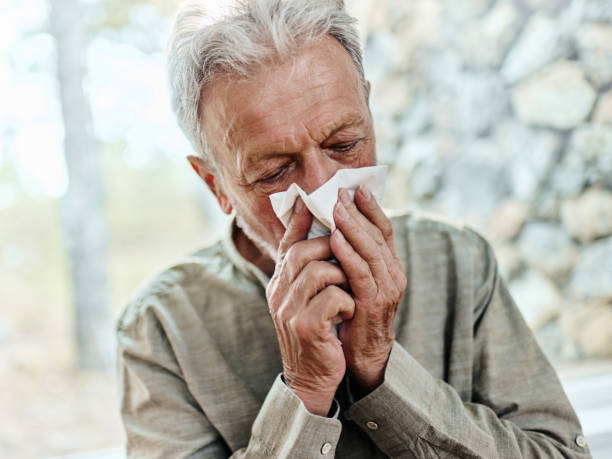 istock Ill senior man blowing a nose at home. 1425111796