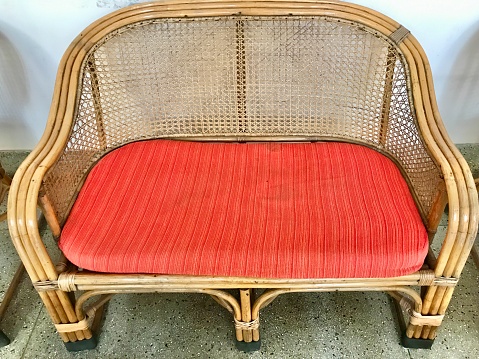 An elegant can sofa with orange seat.