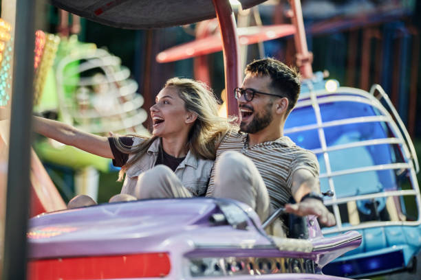 istock Cheerful couple having fun during amusement park ride. 1425111954