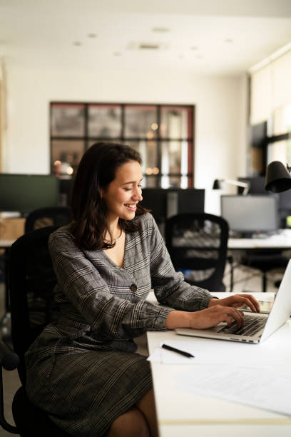 istock Beautiful young businesswoman in office. 1425112328