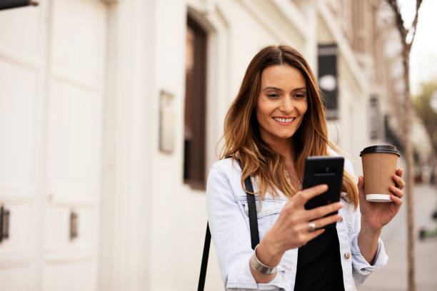 istock Young smiling woman typing a message 1425113619