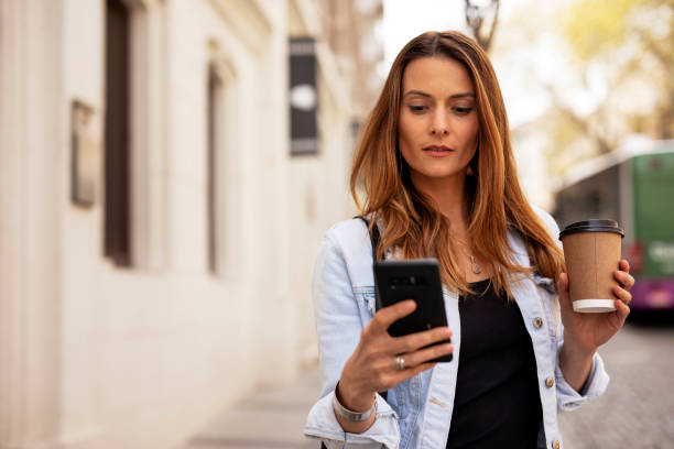 istock Young smiling woman typing a message 1425113653