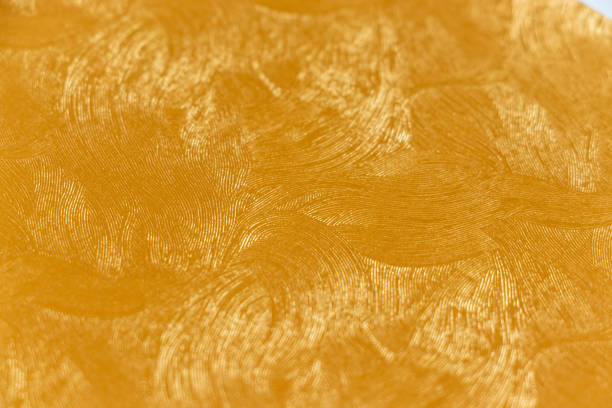 istock Golden wallpaper with fine curved pattern on the surface 1425113864