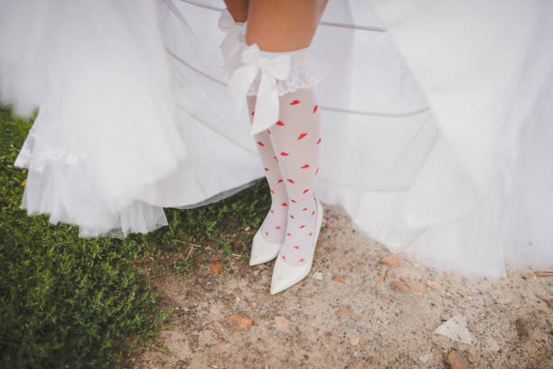 istock The bride on a walk shows her bright stockings 1425113993