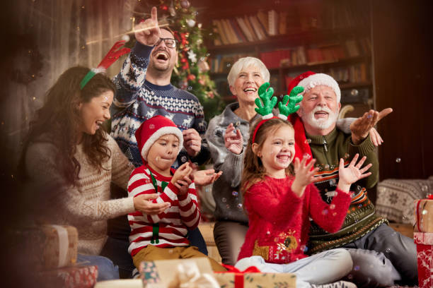 istock Happy multi-generation family having fun while celebrating Christmas at home. 1425114019
