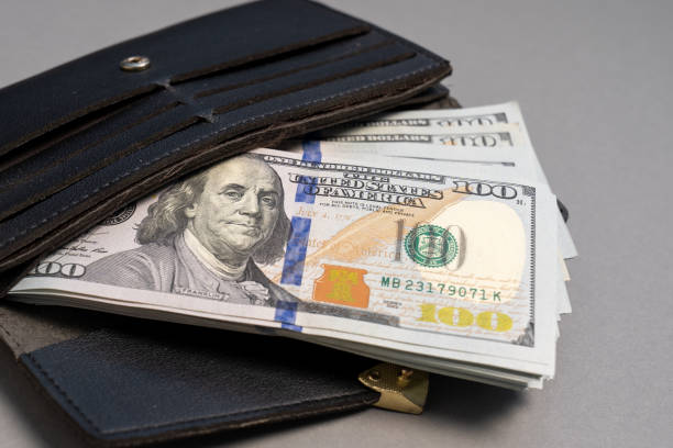 istock American dollar banknotes stack, pack of money in black wallet, rich, luxury, currency, spending money in crisis, benchmark currency, most used in transactions across the world 1425114578